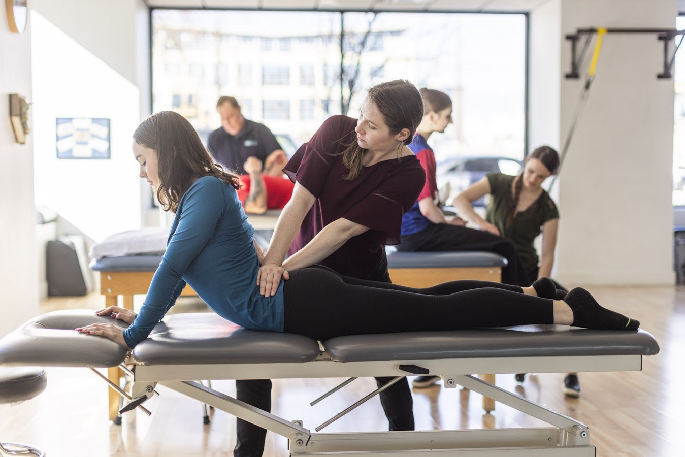 Physical therapist working with a dancer on back stretches.