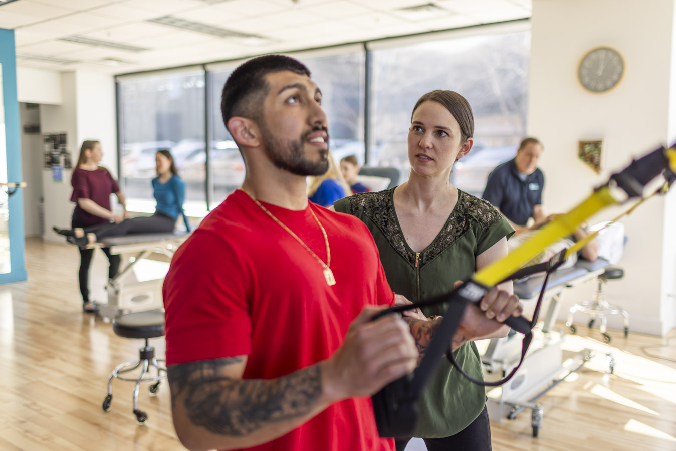 Strength training between a physical therapist and a patient.